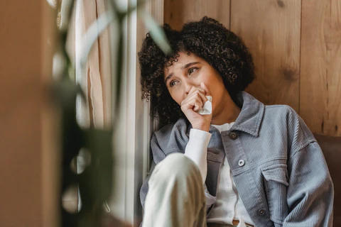 woman crying with tissue in her hand