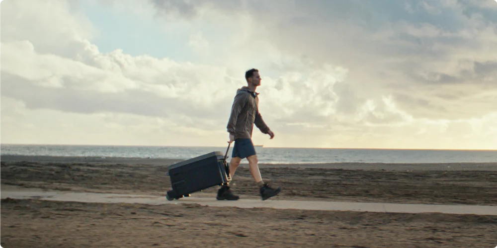 Man tow EcoFlow Glacier portable fridge and freezer on the beach