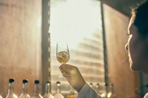 Person holding a glass of additive-free tequila