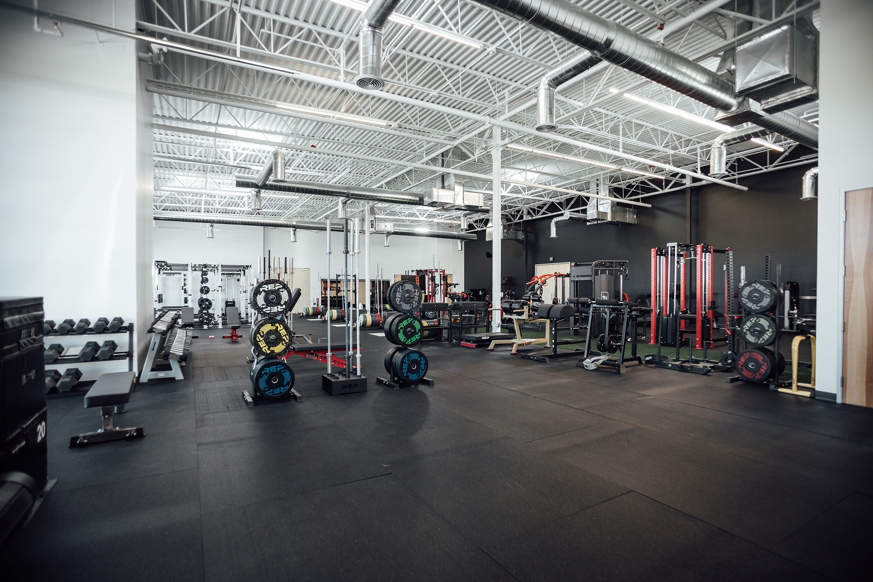 Large open gym featuring REP Fitness products.