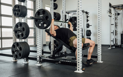 Man doing presses on an incline bench in the gym