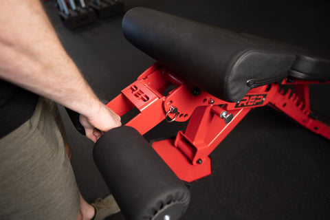 A lifter moving a bench with a handle