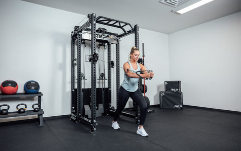 Woman training on an Ares 2.0 cable attachment