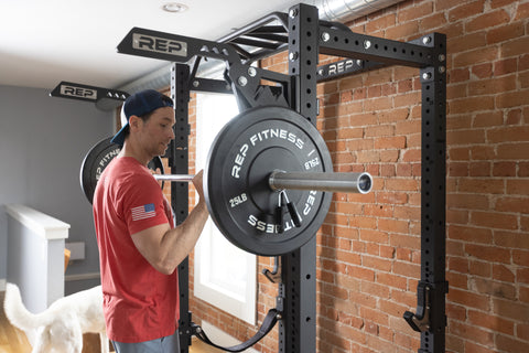 Man holding barbell loaded with weight