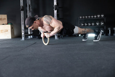 Man doing push-ups on a gymnastic ring