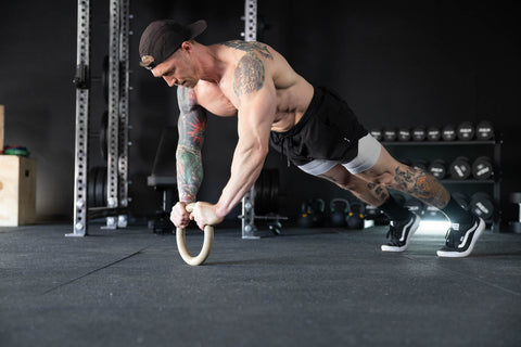 Man doing push-ups on a ring