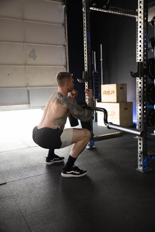 Lifter using a Safety Squat Bar