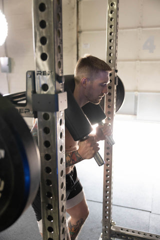 Lifter using a safety squat bar