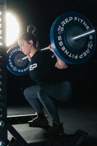 Woman squatting with a barbell