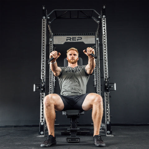 Man lifting on an Athena Side-Mount Functional Trainer