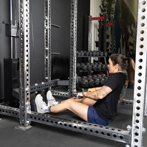 Woman using the low row attachment