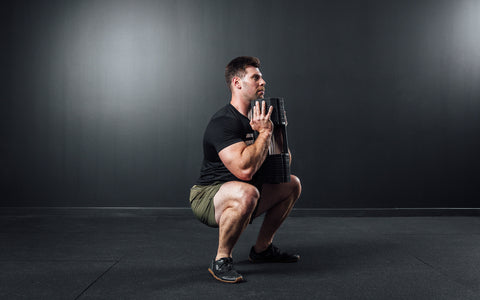 Athlete performing a goblet squat with a single REP x PÉPIN FAST Series Adjustable Dumbbell.