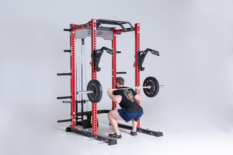 A man squatting in a power rack