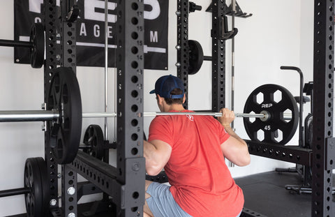 Lifter doing squats in a power rack