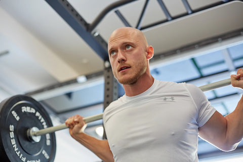 A lifter doing back squats