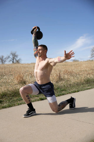 Man working out with a kettlebell outside