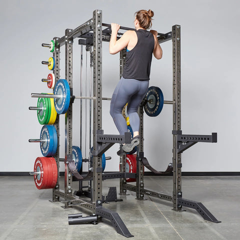 Woman doing pull-ups on a power rack