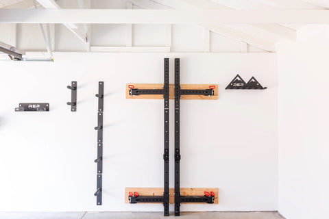 A squat rack folded up on the wall