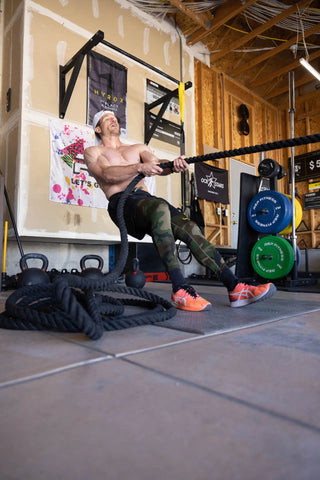 Man pulling a rope in a gym