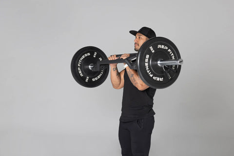 Man doing hammer curls with a cambered Swiss bar