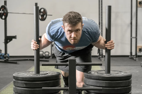 Man pushing a sled