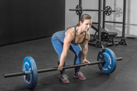 Woman doing deadlifts with an Axle Bar