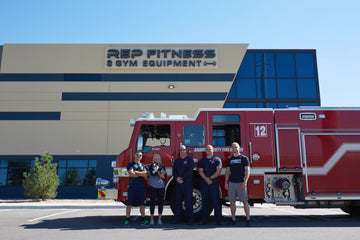 REP Employees Partnered with Firefighters Standing in Front of Fire Truck