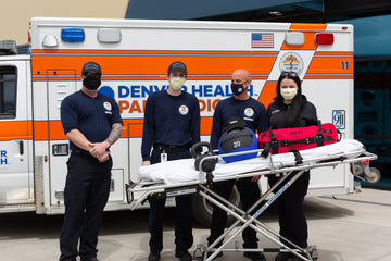 REP Employees With Paramedics In Front of Emergency Vehicle