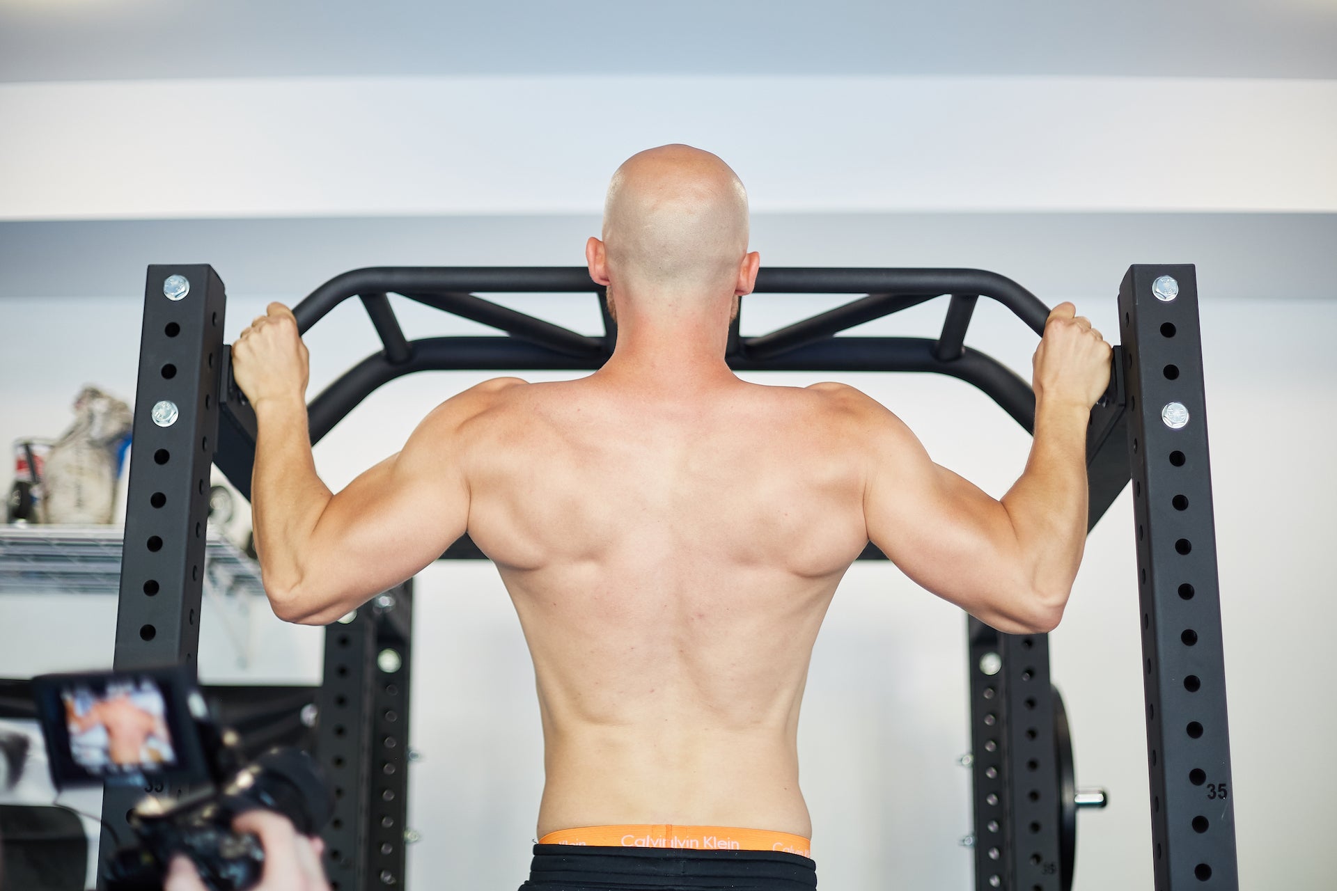 Lifter doing pull-ups on a power rack