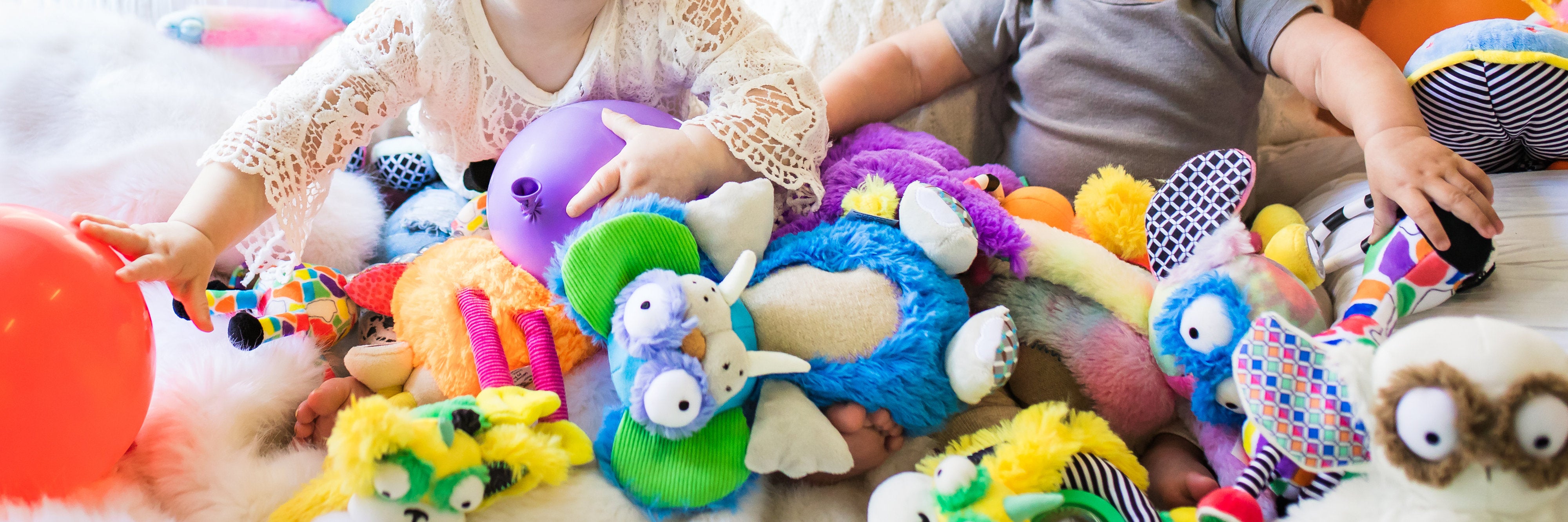colorful baby toys and toddler and baby hands