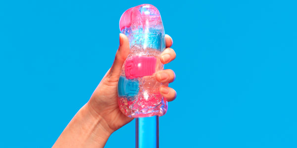 Hand gripping the TENGA Bobble Crazy Cubes