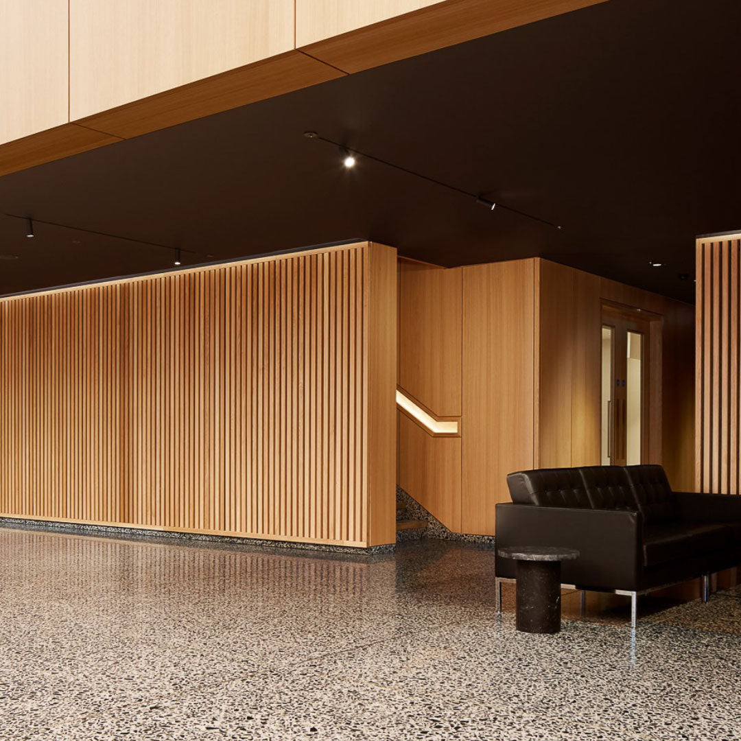 A reception area with a slatted wooden feature wall