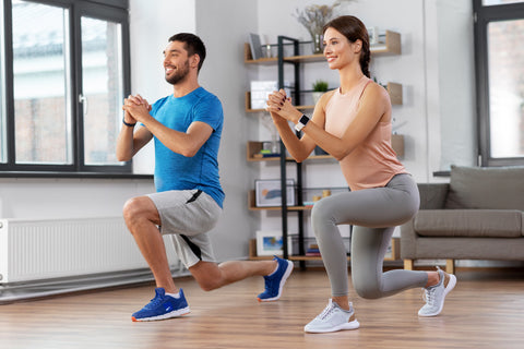 Couple exercising and doing squats at home