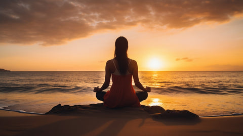 woman meditating at sunset on the seashore