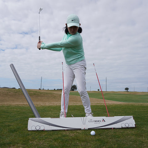 Golfer in backswing with Golf Boks set up for hip sway and inside takeaway.