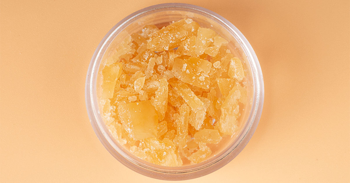 Glass jar with golden cannabis wax