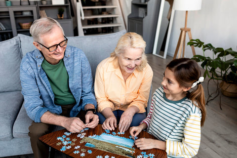 kids solving jigsaw puzzle with grand parents