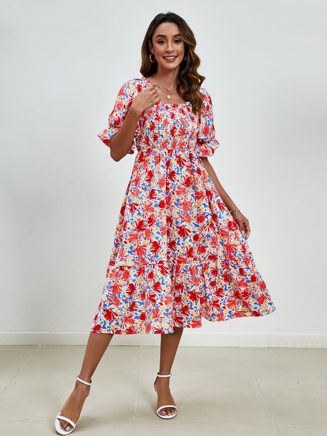 Feminine dress with floral print, smocked bodice, and square neckline, ideal for warm-weather outings.