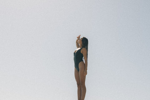 woman wearing Sienna Swim Avila one-piece looks out at the ocean