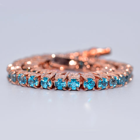 Thai blue zircon made into a tennis bracelet in 18k rose gold. Entirely handmade by Shiraz Jewelry in Chiang Mai, Thailand.