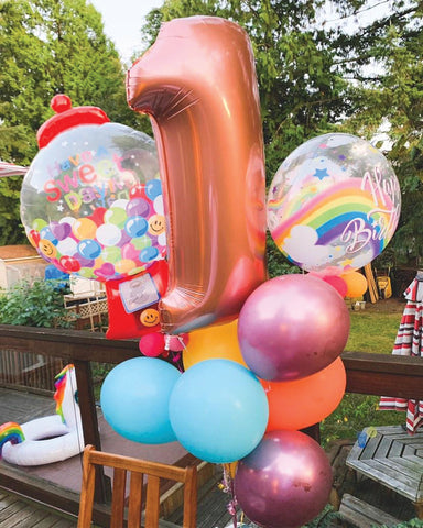 Gumball machine balloons and rainbow bubble balloons with rosegold megaloon number 1 balloon by VancouverBalloons