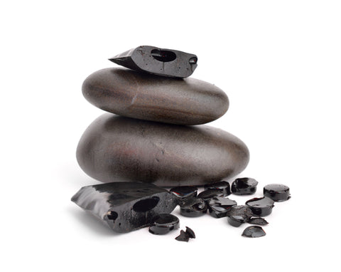 Shilajit, Mumijo with stones isolated on a white background.