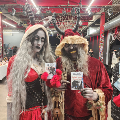 Krampus cosplayers hold Bleak Boutique products