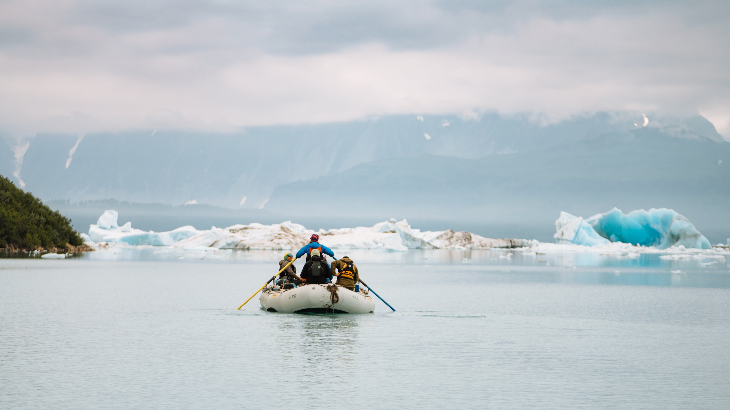 A raft on the Tatshenshini river surrounded by icebergs