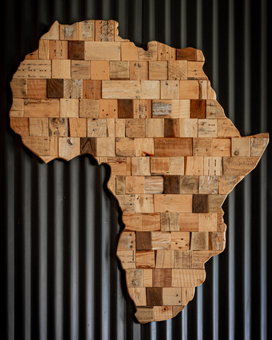 Wooden blocks form the shape of the continent of Africa, against a corrugated black background.