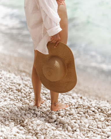 Girl wearing sunscreen on beach