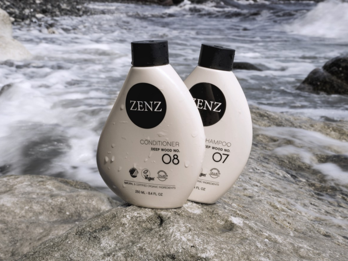 Shampoo no. 07 and Conditioner no. 08 Deep Wood from ZENZ Organic on a rock in water