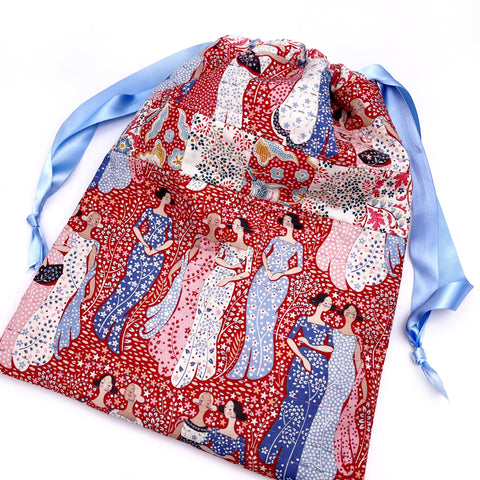 Hand stitched drawstring bag featuring ladies in long dresses chatting 