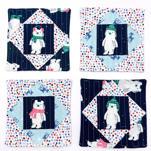 Four coasters featuring winter bears with hats on in the centre