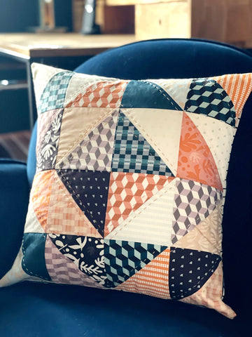 Patchwork cushion on chair hand quilted with 8 weight Aurifil thread